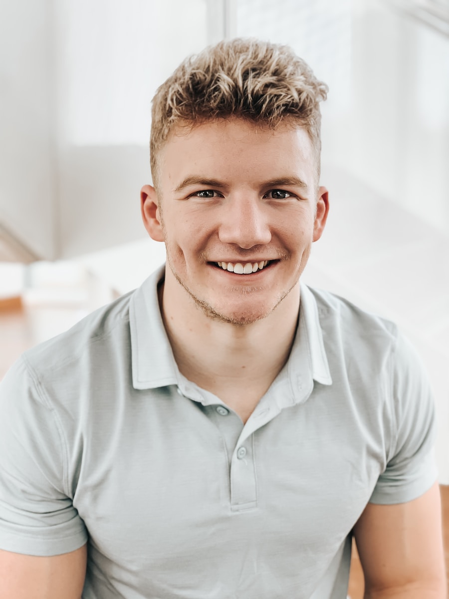 man in gray polo shirt smiling